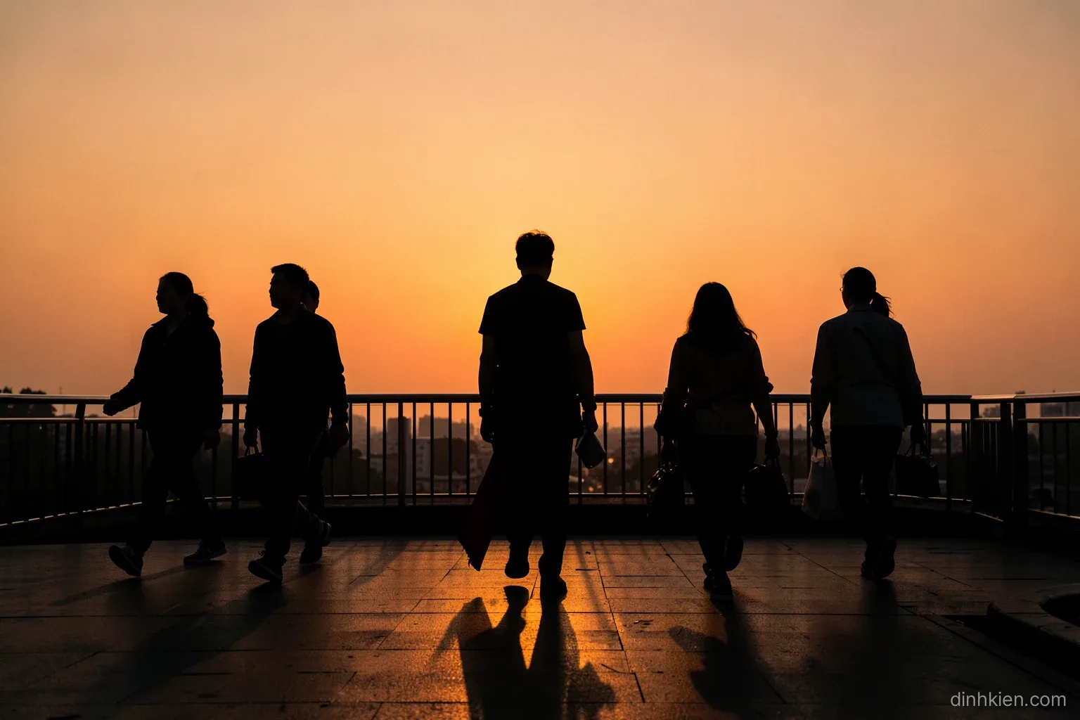 Silhouettes of several Vietnamese pedestrians of different builds walking across a pedestrian bridge at dusk, long shadows, warm orange sky, wide telephoto compression